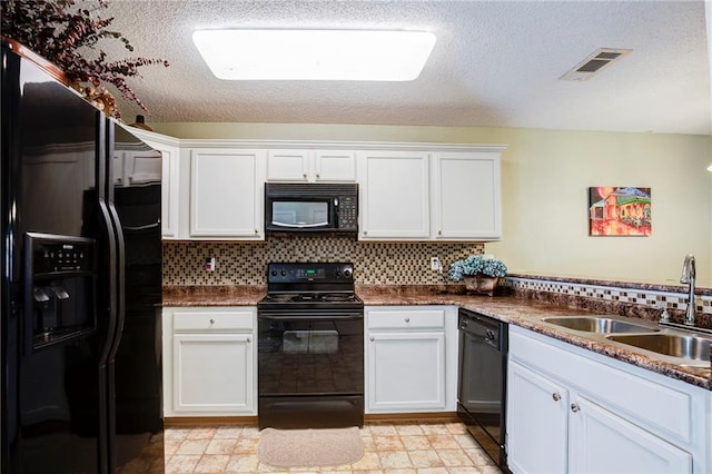 1700 Marseille Dr Unit 2, La Place, LA 70068 - kitchen with visible vents, a sink, black appliances, white cabinetry, and tasteful backsplash