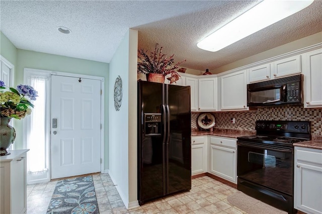 1700 Marseille Dr Unit 2, La Place, LA 70068 - kitchen featuring dark countertops, black appliances, light floors, decorative backsplash, and white cabinetry