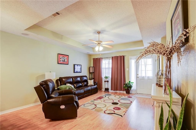 1700 Marseille Dr Unit 2, La Place, LA 70068 - living room with wood finished floors, baseboards, visible vents, a textured ceiling, and a raised ceiling