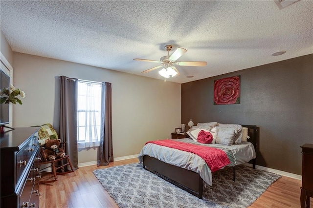 1700 Marseille Dr Unit 2, La Place, LA 70068 - bedroom featuring baseboards, a textured ceiling, a ceiling fan, and light wood-style floors