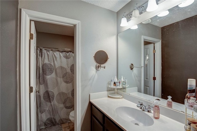 1700 Marseille Dr Unit 2, La Place, LA 70068 - full bathroom with a shower with shower curtain, toilet, vanity, and a textured ceiling