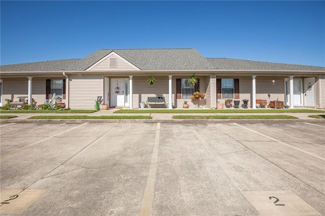 1700 Marseille Dr Unit 2, La Place, LA 70068 - view of front of property with uncovered parking, covered porch, and roof with shingles