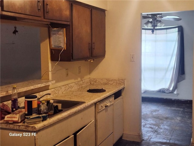 kitchen with baseboards, dishwasher, ceiling fan, and light countertops