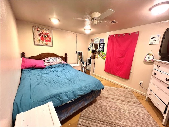 bedroom featuring baseboards and visible vents