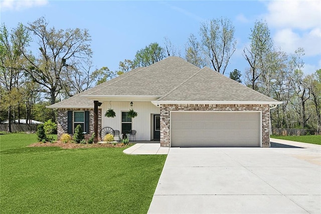 41379 Schafer Dr, Hammond, LA 70403 - view of front facade with concrete driveway, a garage, a front yard, and a shingled roof
