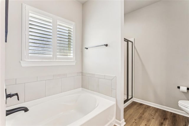 41379 Schafer Dr, Hammond, LA 70403 - bathroom featuring a bath, a shower stall, and wood finished floors