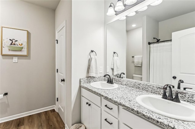 41379 Schafer Dr, Hammond, LA 70403 - full bathroom featuring double vanity and wood finished floors