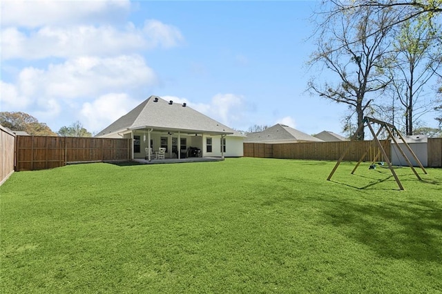 41379 Schafer Dr, Hammond, LA 70403 - rear view of house featuring a fenced backyard, ceiling fan, a patio area, and a playground