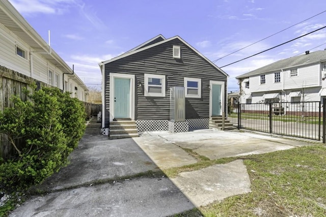 back of house with entry steps and fence