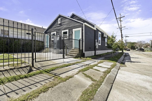 view of side of home featuring a gate and fence