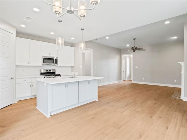 72694 Robindale Dr, Covington, LA 70435 - kitchen featuring white cabinets, recessed lighting, appliances with stainless steel finishes, light countertops, and light wood finished floors