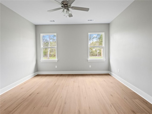 72694 Robindale Dr, Covington, LA 70435 - unfurnished room featuring light wood-style floors, baseboards, visible vents, and a wealth of natural light