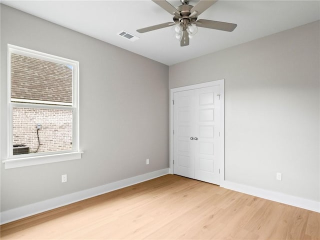 72694 Robindale Dr, Covington, LA 70435 - unfurnished bedroom with a closet, baseboards, light wood-style flooring, a ceiling fan, and visible vents