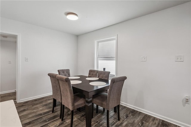 dining room featuring baseboards and wood finished floors