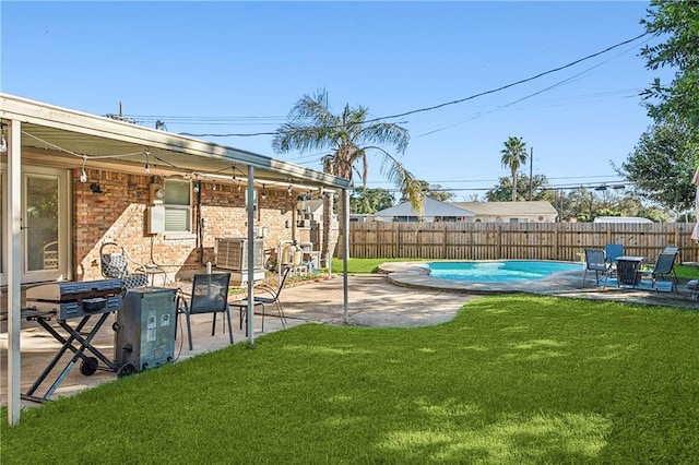 view of yard featuring a patio, a fenced backyard, and a fenced in pool