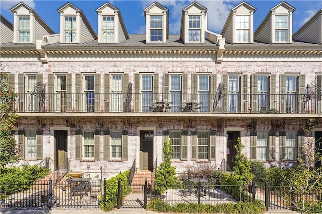 2109 Prytania St, New Orleans, LA 70130 - view of front of property with brick siding, entry steps, and a fenced front yard