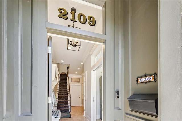 2109 Prytania St, New Orleans, LA 70130 - entryway with crown molding, a chandelier, stairs, and recessed lighting