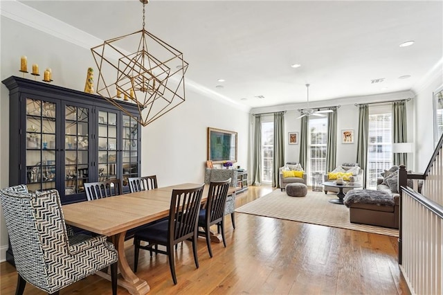 2109 Prytania St, New Orleans, LA 70130 - dining area featuring wood-type flooring, a chandelier, crown molding, ceiling fan, and recessed lighting
