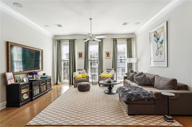 2109 Prytania St, New Orleans, LA 70130 - living area featuring crown molding, wood finished floors, a ceiling fan, and baseboards