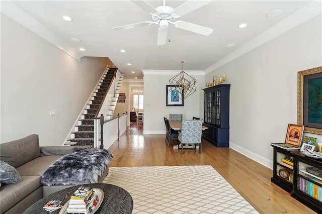 2109 Prytania St, New Orleans, LA 70130 - living room featuring light wood-style flooring, ornamental molding, baseboards, a chandelier, and stairs