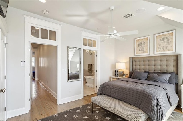 2109 Prytania St, New Orleans, LA 70130 - bedroom featuring wood finished floors, baseboards, recessed lighting, and connected bathroom