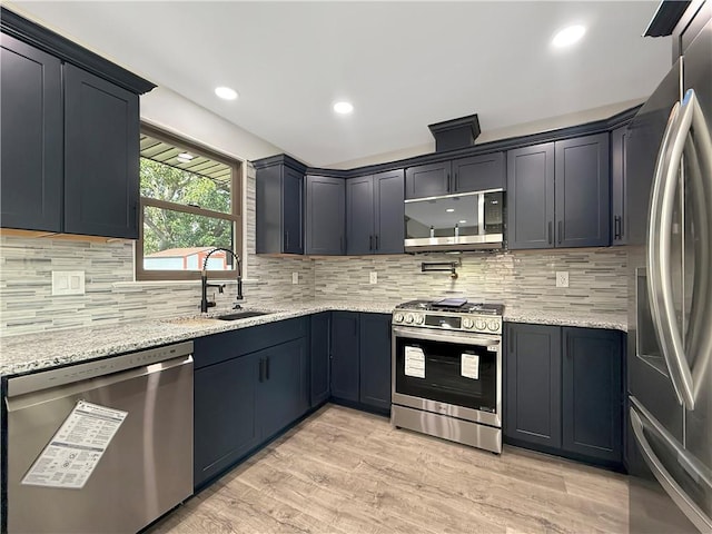 508 Sena Dr, Metairie, LA 70005 - kitchen with appliances with stainless steel finishes, light stone counters, light wood-type flooring, backsplash, and recessed lighting