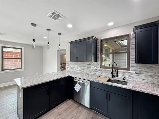 508 Sena Dr, Metairie, LA 70005 - kitchen with stainless steel dishwasher, a peninsula, decorative backsplash, light stone countertops, and recessed lighting