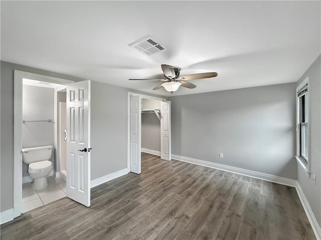 508 Sena Dr, Metairie, LA 70005 - unfurnished bedroom featuring wood finished floors, a closet, ensuite bathroom, and ceiling fan