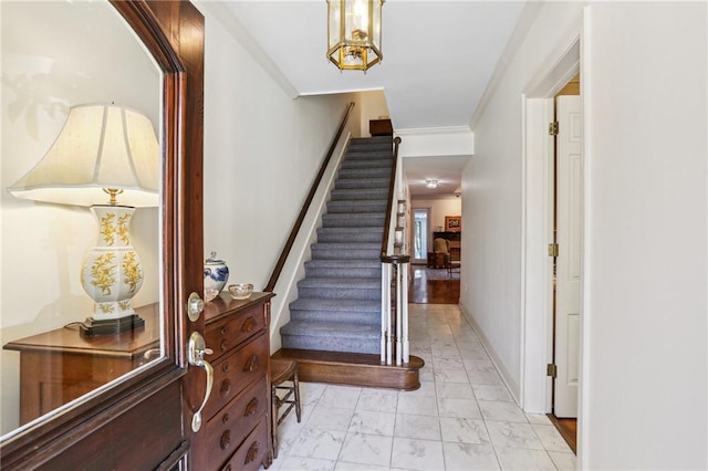 805 Rue Royal St, Metairie, LA 70005 - stairs featuring marble finish floor, crown molding, and baseboards