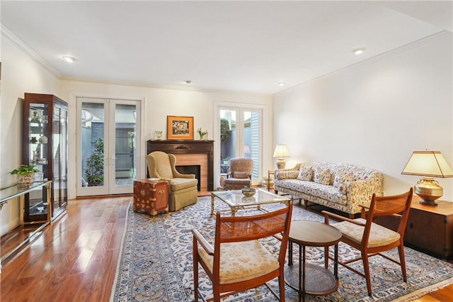 805 Rue Royal St, Metairie, LA 70005 - living area featuring a fireplace, crown molding, wood finished floors, and french doors