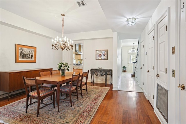 805 Rue Royal St, Metairie, LA 70005 - dining space with visible vents, a notable chandelier, and dark wood-style floors