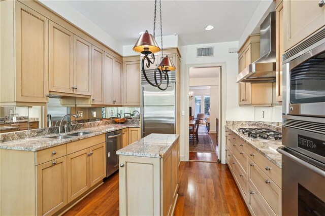 805 Rue Royal St, Metairie, LA 70005 - kitchen with dark wood finished floors, wall chimney range hood, appliances with stainless steel finishes, and a sink