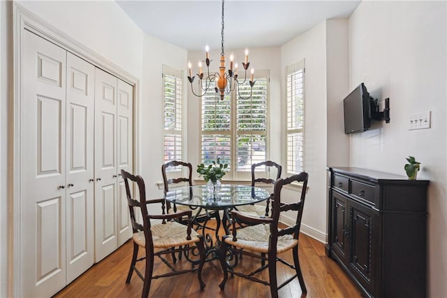 805 Rue Royal St, Metairie, LA 70005 - dining area featuring dark wood-style floors, baseboards, and a chandelier