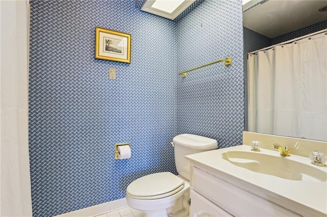805 Rue Royal St, Metairie, LA 70005 - bathroom with toilet, vanity, and tile patterned flooring