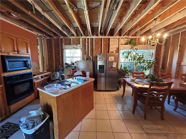 962 Magnolia Ridge Rd, Boutte, LA 70039 - kitchen featuring a center island, light tile patterned flooring, brown cabinets, light countertops, and black appliances