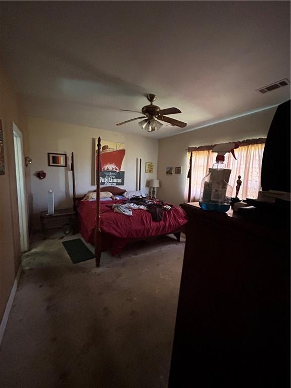 962 Magnolia Ridge Rd, Boutte, LA 70039 - bedroom with carpet floors, a ceiling fan, visible vents, and baseboards