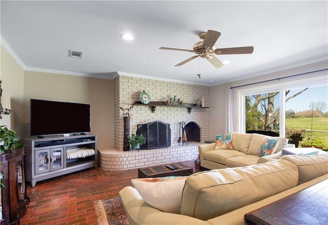 6 Country Club Dr, La Place, LA 70068 - living room with visible vents, ornamental molding, a fireplace, brick floor, and a ceiling fan
