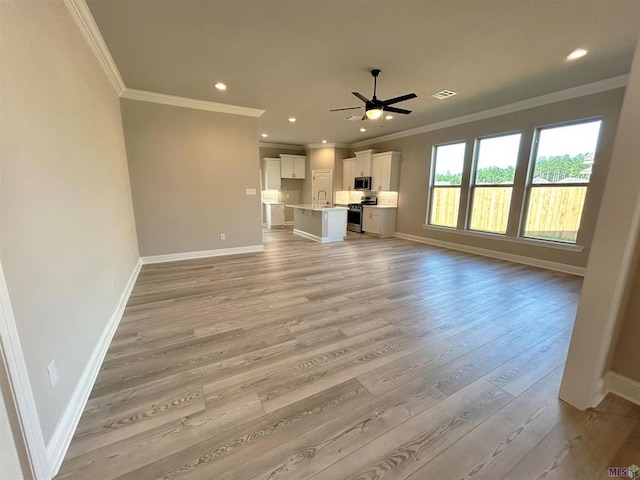 25307 Angele Dr, Ponchatoula, LA 70454 - unfurnished living room featuring crown molding, a ceiling fan, light wood-style floors, and recessed lighting