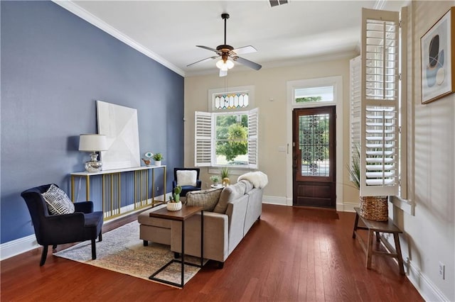 living room featuring visible vents, baseboards, ceiling fan, ornamental molding, and wood-type flooring