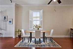 dining space featuring baseboards, ceiling fan, and wood finished floors