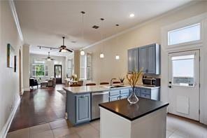 kitchen with stainless steel dishwasher, a peninsula, ceiling fan, and crown molding