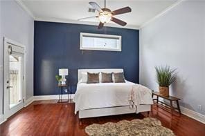 bedroom featuring wood finished floors, baseboards, and ornamental molding