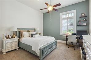 bedroom featuring light colored carpet, a ceiling fan, and baseboards