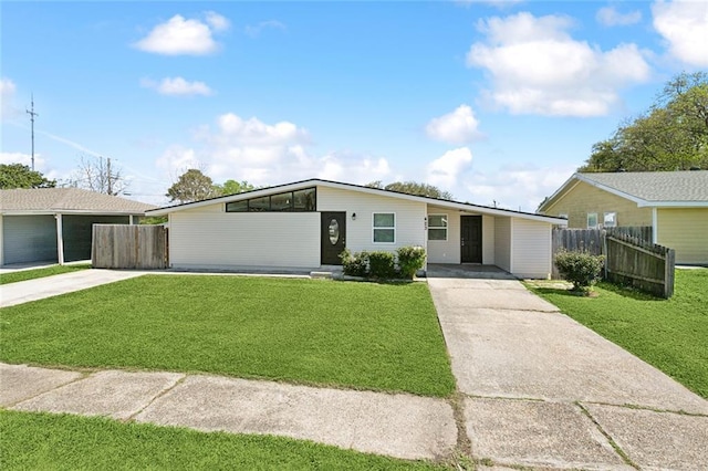 423 Bruce Ave, Terrytown, LA 70056 - mid-century modern home featuring a front yard, an attached carport, and driveway