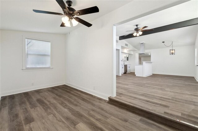 423 Bruce Ave, Terrytown, LA 70056 - unfurnished living room with lofted ceiling with beams, baseboards, dark wood-type flooring, and ceiling fan