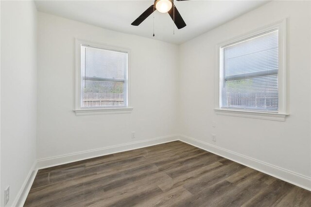 423 Bruce Ave, Terrytown, LA 70056 - unfurnished room featuring dark wood-style floors, a healthy amount of sunlight, and baseboards
