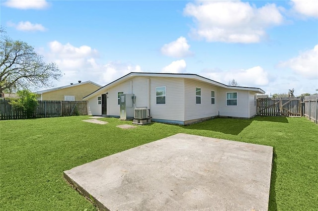 423 Bruce Ave, Terrytown, LA 70056 - rear view of property featuring a lawn, central AC, a fenced backyard, and a patio area