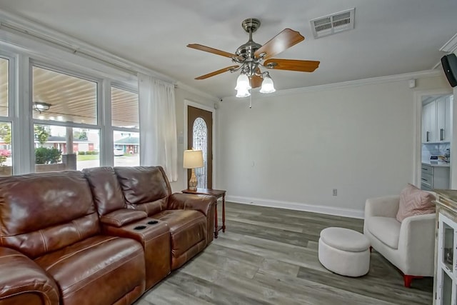 9025 Camille Ct, River Ridge, LA 70123 - living area featuring visible vents, baseboards, ornamental molding, ceiling fan, and wood finished floors