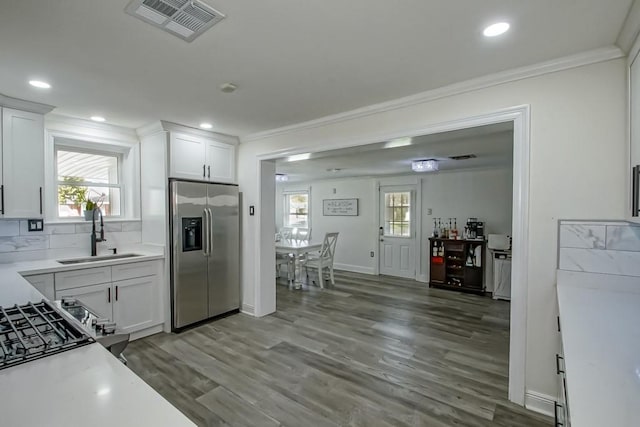 9025 Camille Ct, River Ridge, LA 70123 - kitchen with crown molding, a sink, stainless steel fridge with ice dispenser, wood finished floors, and visible vents