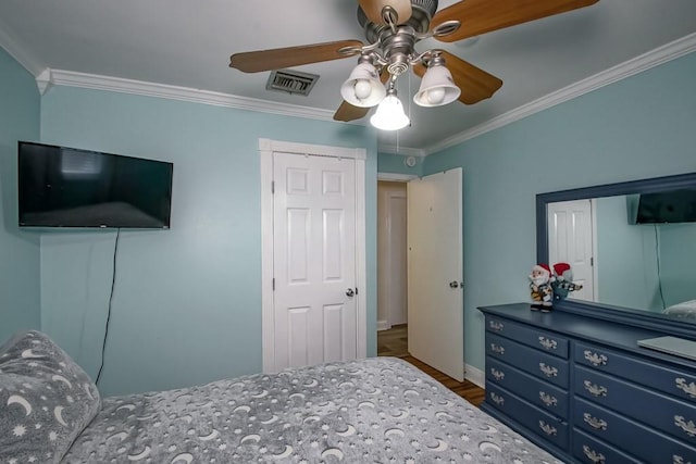 9025 Camille Ct, River Ridge, LA 70123 - bedroom with crown molding, baseboards, ceiling fan, visible vents, and wood finished floors